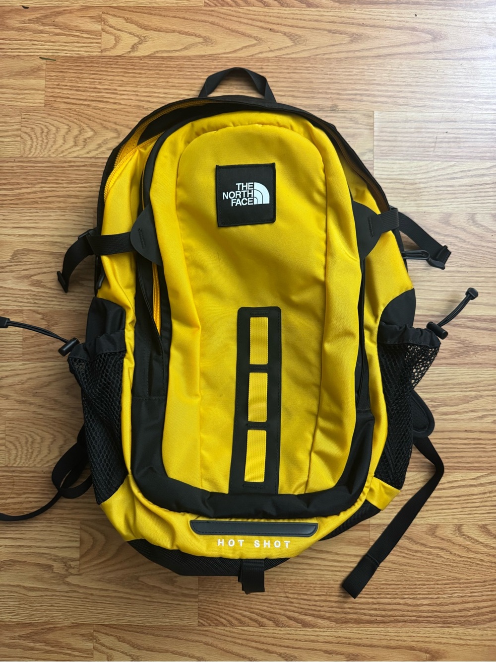 The North Face Hot Shot SE Backpack in bright yellow with black accents